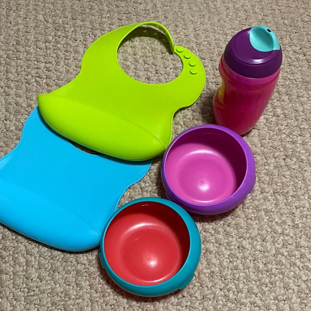2 bibs, green & blue, 2 suction bowls, pink & purple, 1 tommie tippie sippie cup